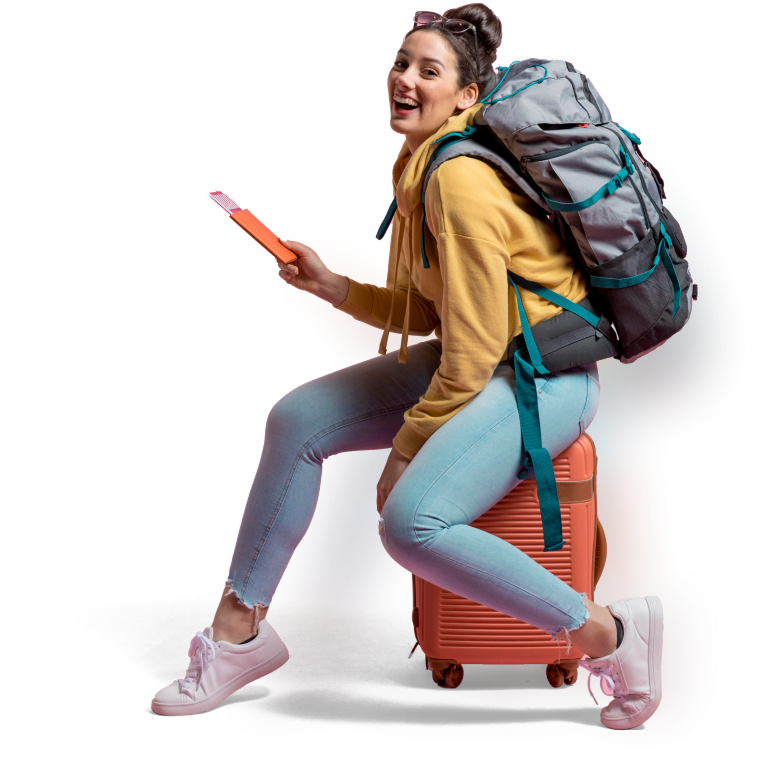 Happy women sitting on a suitcase